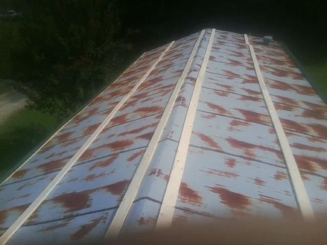 Rusted metal roof panels with new wood purlins before replacement — Storm Damage Roof Repair in Monterey by Roofing Brothers