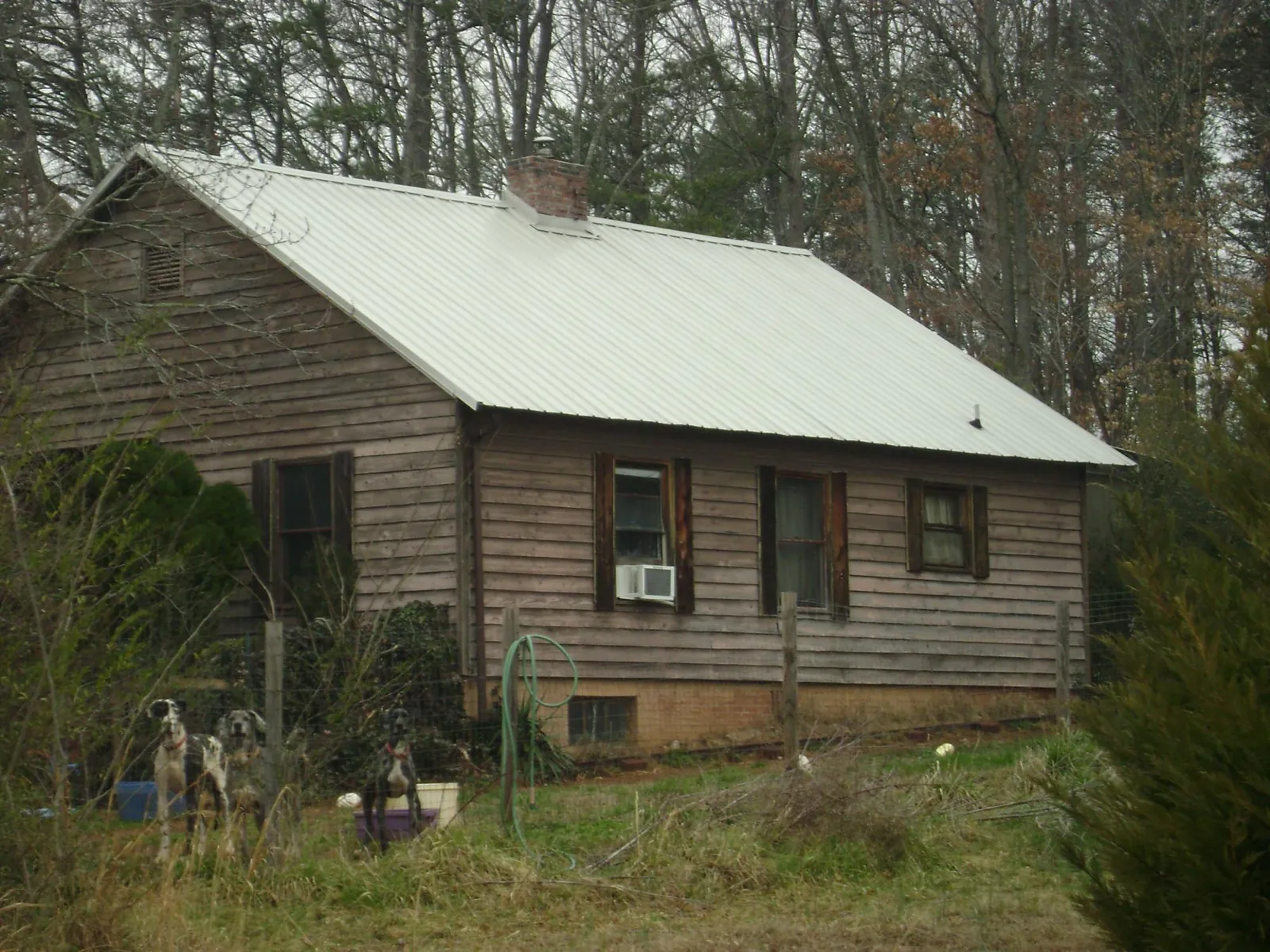 White metal roof on an old wood sided farmhouse, from a Metal Roof Installation job in Monterey
